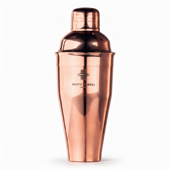 A copper-colored metal cocktail shaker with a matching lid, featuring the 'Rusty Barrel London' logo on the front, set against a plain white background.